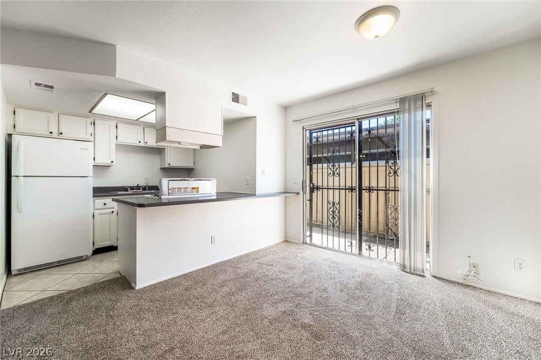 535 Sellers Place, Henderson, NV 89011 A spacious carpeted dining area transitions seamlessly into the kitchen and out to the patio.