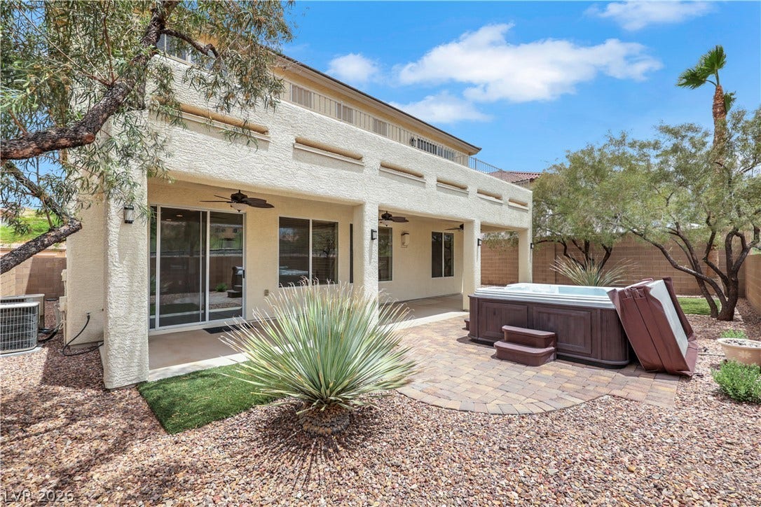 625 Bighorn Creek Street, Henderson, NV 89002 An inviting covered patio and hot tub await in this private, landscaped backyard.