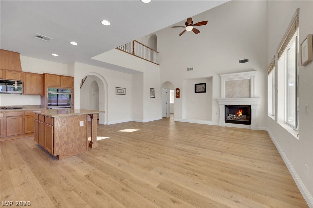 625 Bighorn Creek Street, Henderson, NV 89002 High ceilings and clean hardwood floors frame an open layout complete with a classic fireplace.