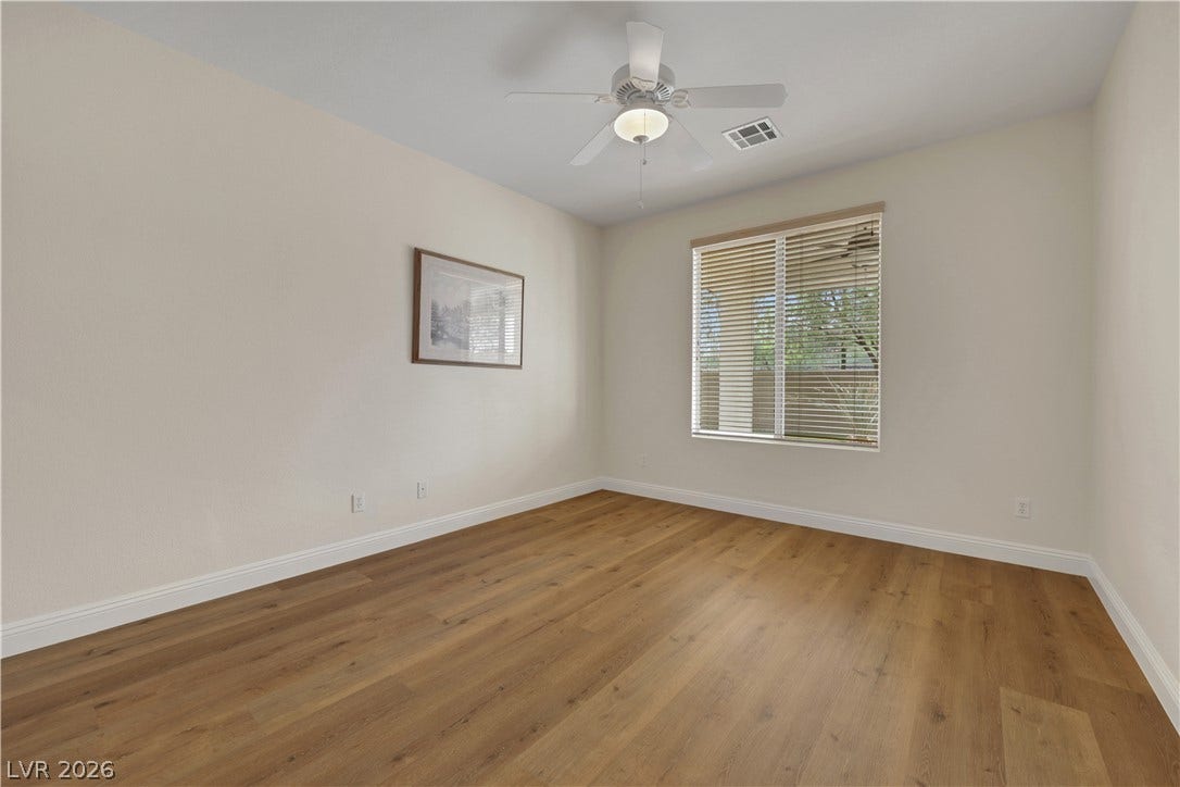 625 Bighorn Creek Street, Henderson, NV 89002 Smooth wood floors anchor this clean, neutral space illuminated by a wide window.
