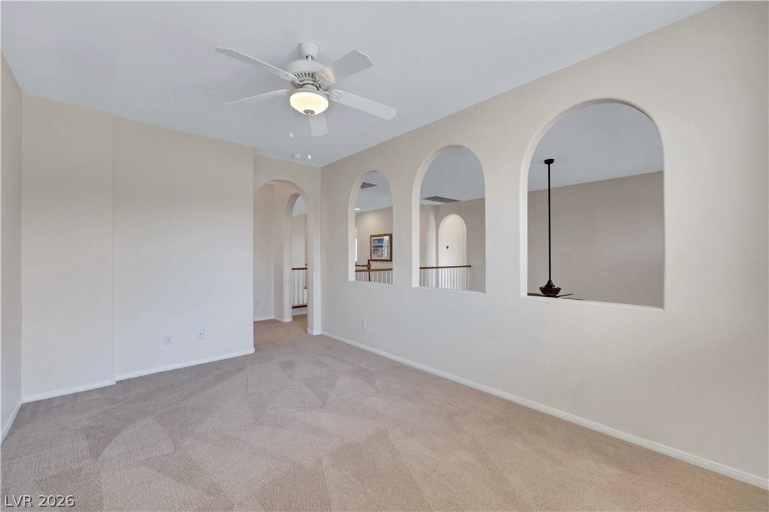 625 Bighorn Creek Street, Henderson, NV 89002 Archways and a soft neutral carpet define this adaptable loft space, perfect for quiet retreats or lively gatherings.
