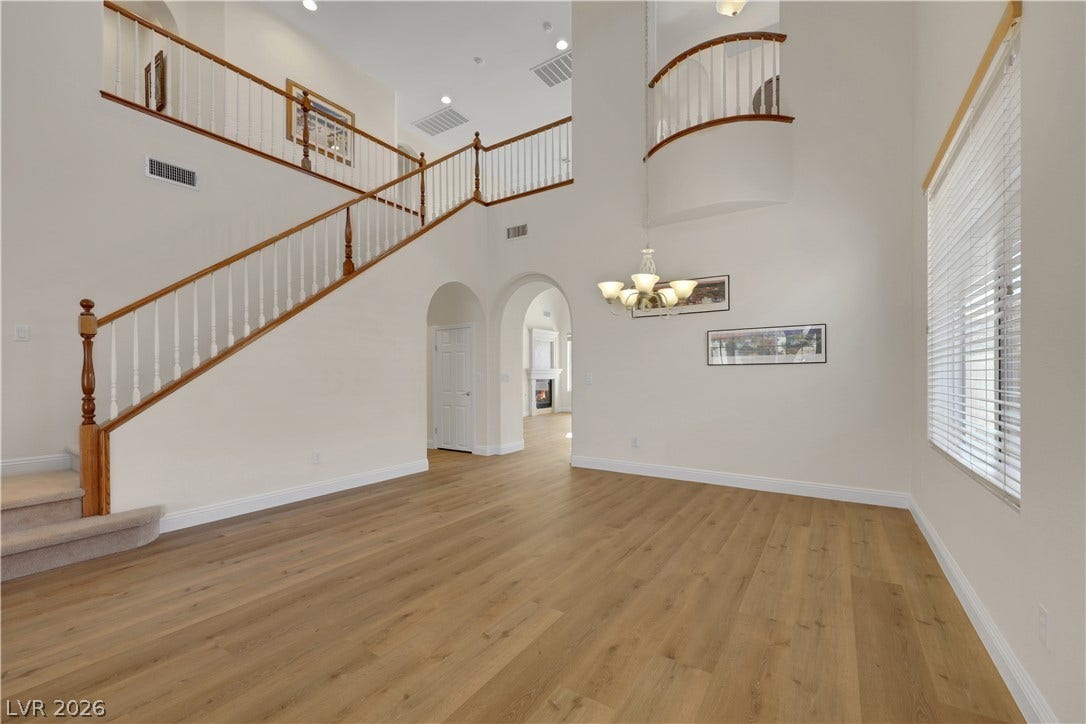 625 Bighorn Creek Street, Henderson, NV 89002 Soaring ceilings and warm wood floors anchor this grand multi-level entryway.