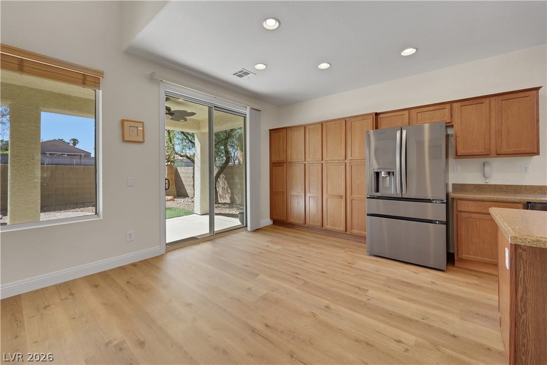 625 Bighorn Creek Street, Henderson, NV 89002 Warm wood flooring meets matching cabinetry in this bright kitchen and casual dining area.