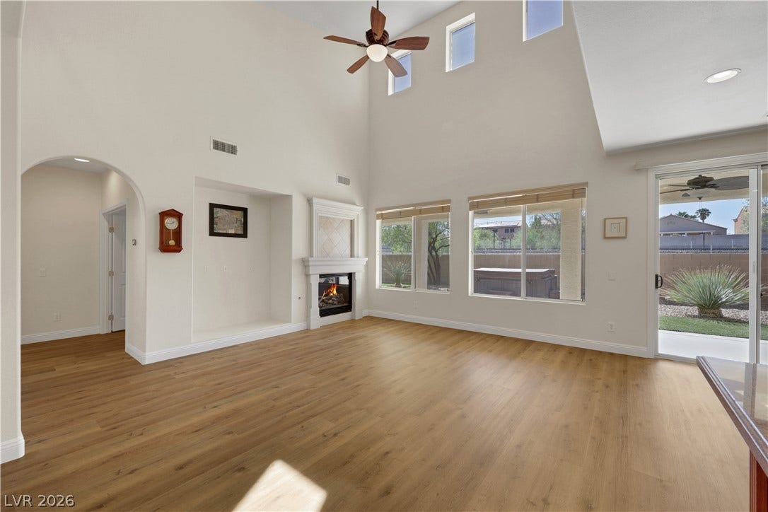 625 Bighorn Creek Street, Henderson, NV 89002 High ceilings and clean wood-plank flooring define this airy living space with a warm fireplace.