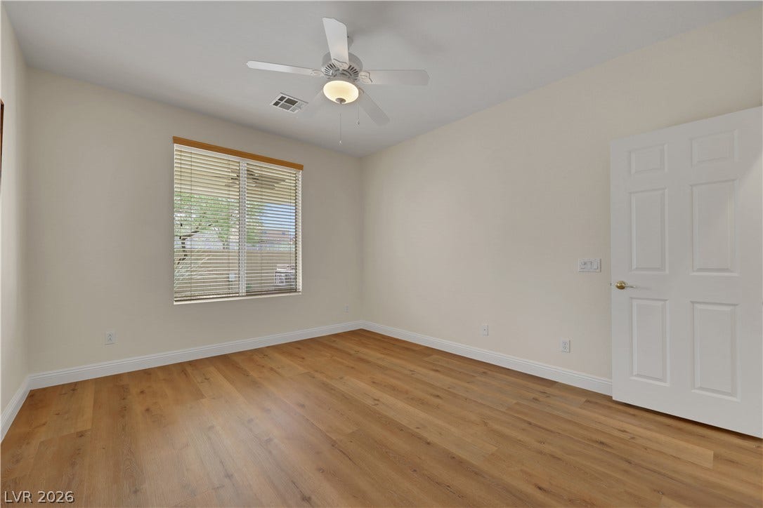 625 Bighorn Creek Street, Henderson, NV 89002 Warm wood floors and a large window define this inviting, clean-lined bedroom space.