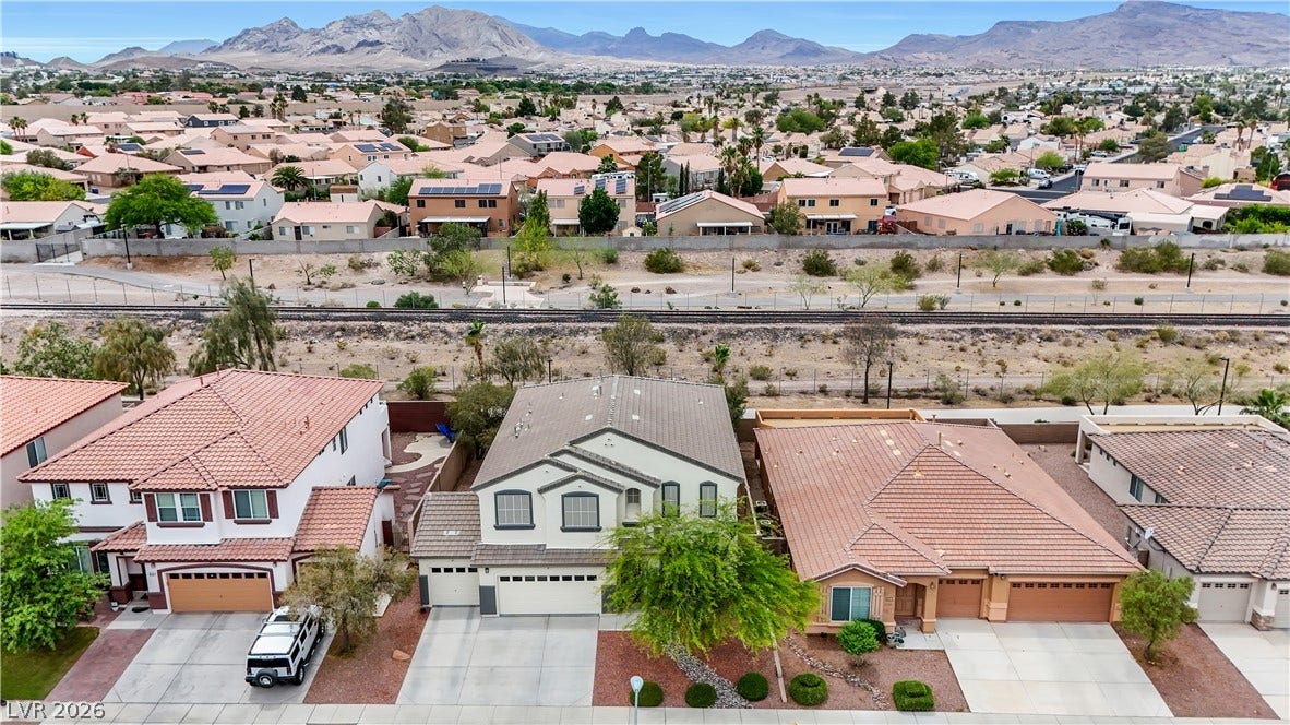 625 Bighorn Creek Street, Henderson, NV 89002 An aerial perspective reveals a residential neighborhood with desert landscaping and a backdrop of distant mountains.