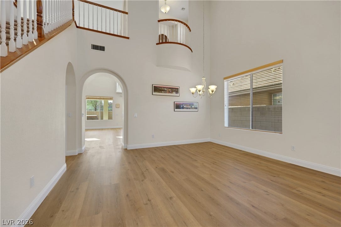 625 Bighorn Creek Street, Henderson, NV 89002 Dramatic high ceilings and warm wood floors elevate this versatile main-level living space.