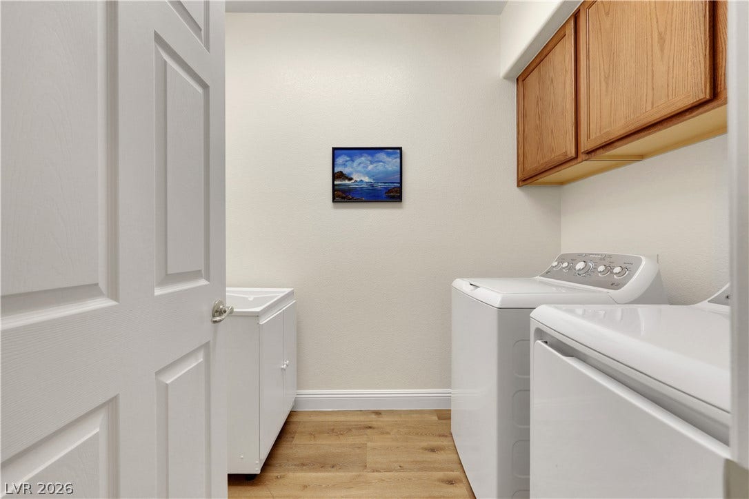 625 Bighorn Creek Street, Henderson, NV 89002 Functional workspace features built-in upper cabinetry, utility sink, and durable wood-look flooring.