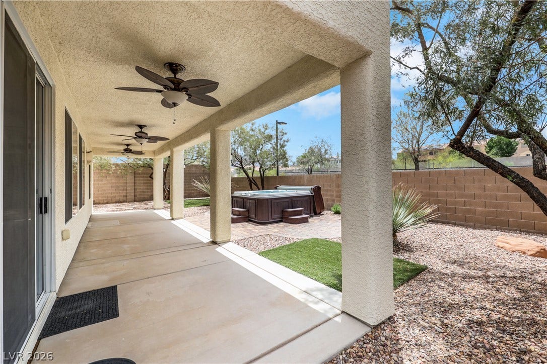 625 Bighorn Creek Street, Henderson, NV 89002 A spacious covered patio provides a shaded oasis, complemented by a bubbling spa for ultimate outdoor relaxation.
