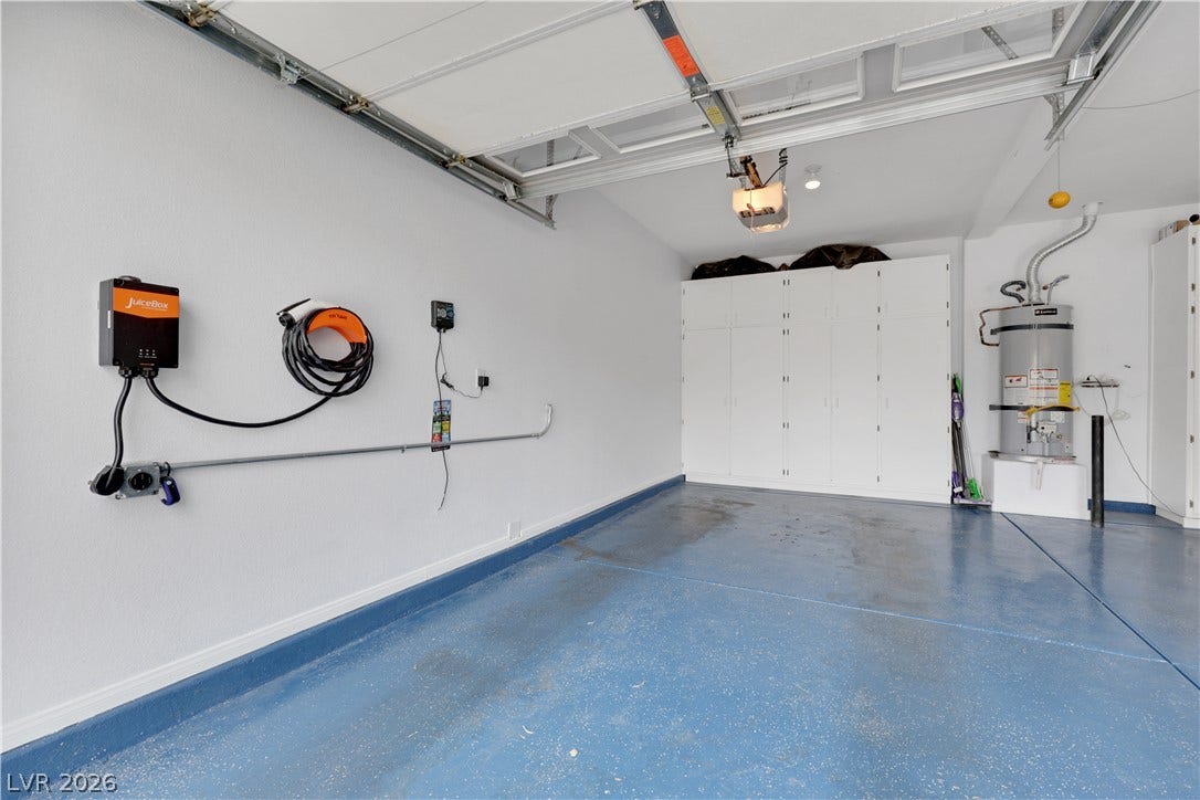 625 Bighorn Creek Street, Henderson, NV 89002 A well-organized garage features abundant cabinetry and a dedicated electric vehicle charging station.