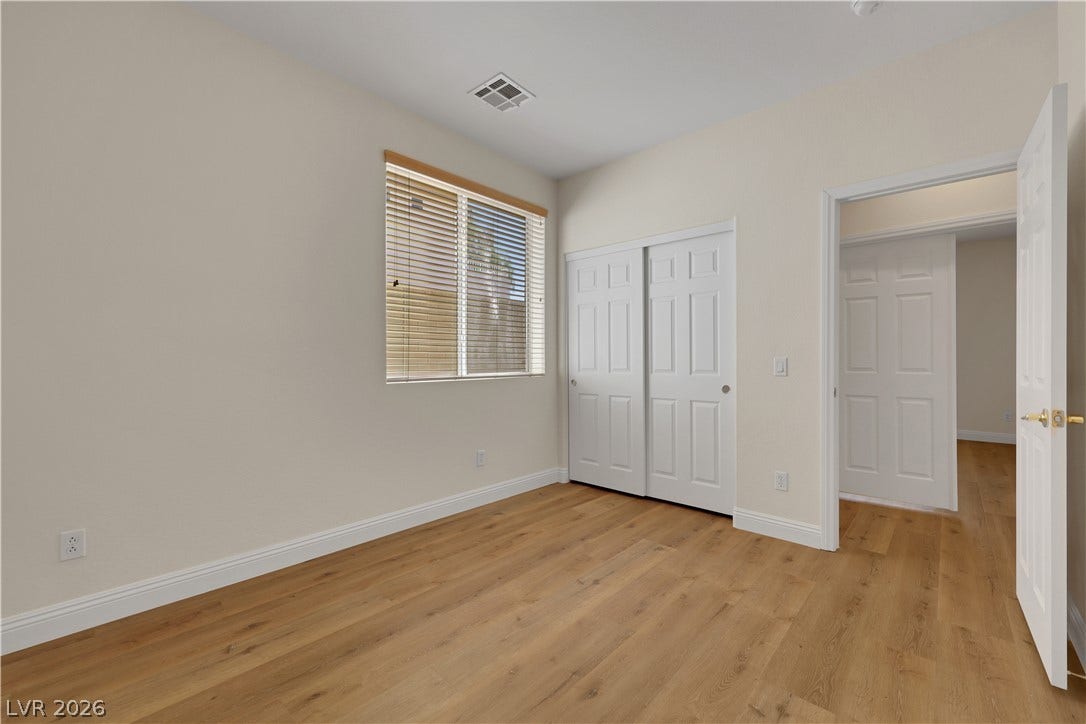 625 Bighorn Creek Street, Henderson, NV 89002 Warm wood flooring and clean baseboards anchor this inviting bedroom space.