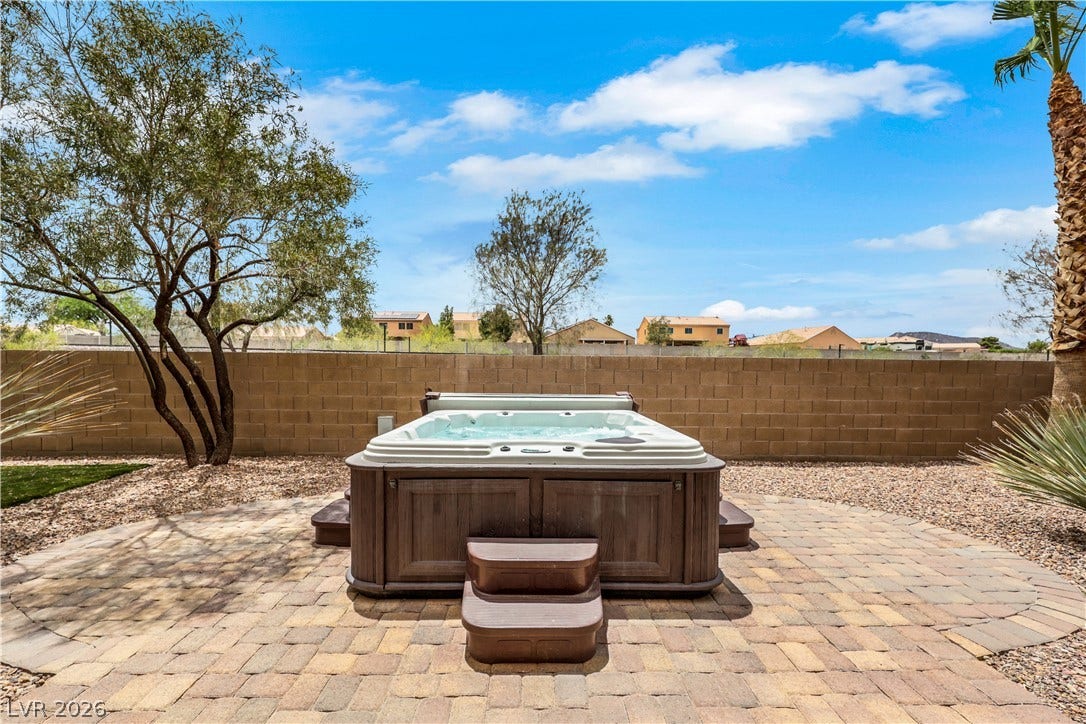 625 Bighorn Creek Street, Henderson, NV 89002 Relax and unwind in the private spa nestled on a brick paver patio, encircled by natural landscaping.