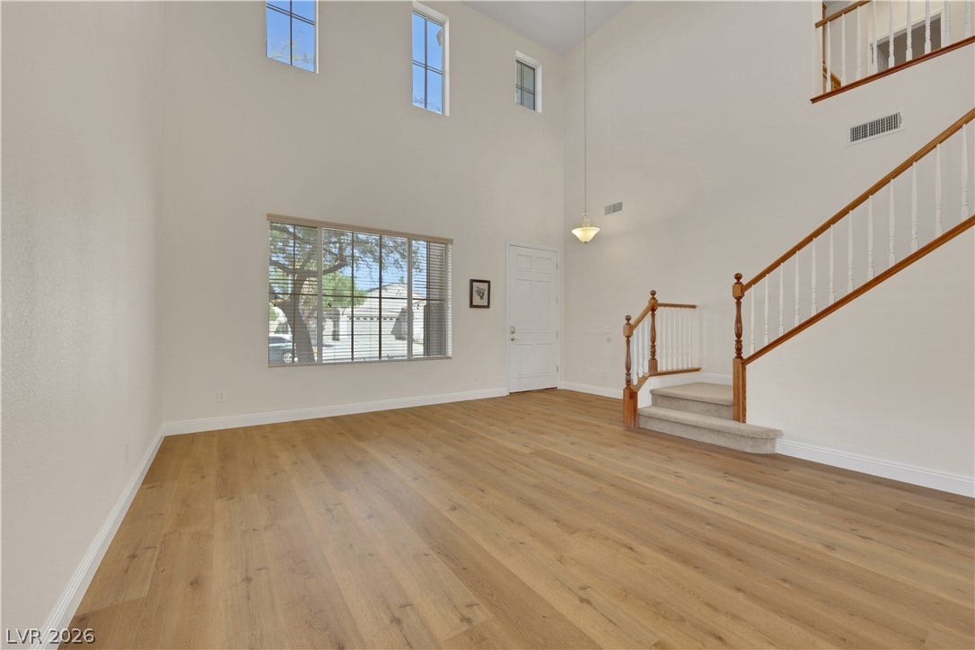 625 Bighorn Creek Street, Henderson, NV 89002 Double-height ceilings and rich wood floors define this airy entryway space.