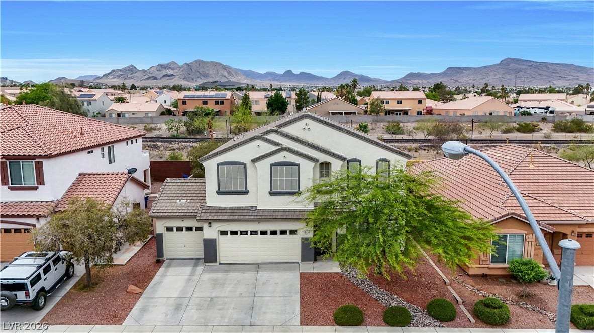 625 Bighorn Creek Street, Henderson, NV 89002 A traditional two-story residence with a three-car garage and manicured landscaping, nestled in a community with mountain views.
