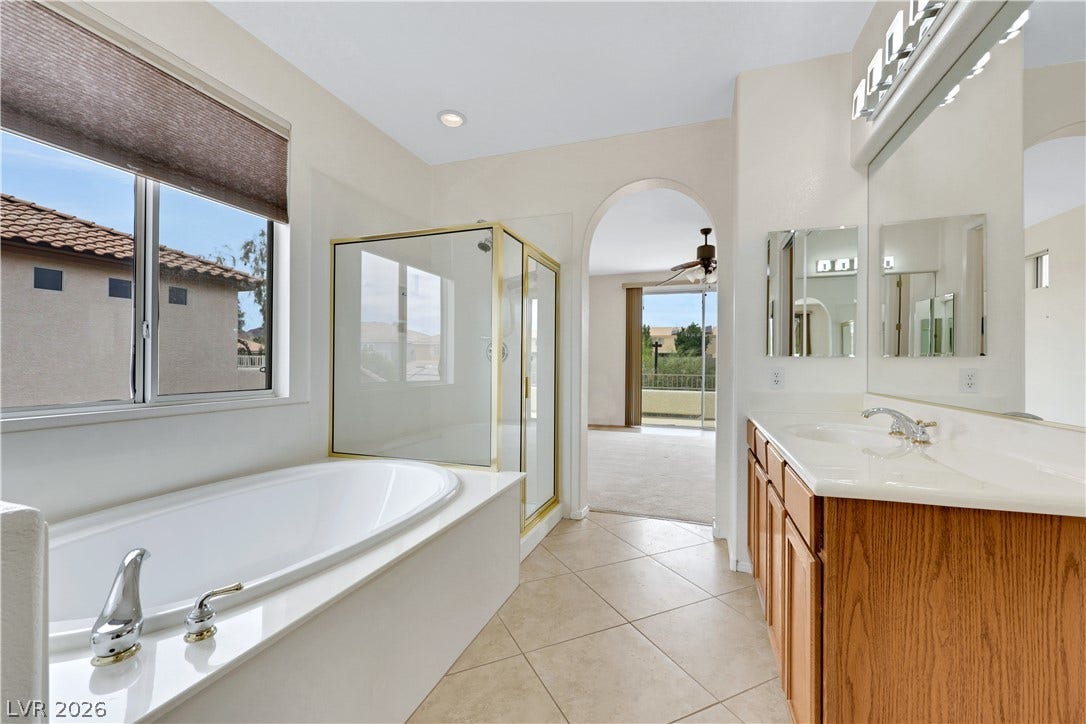 625 Bighorn Creek Street, Henderson, NV 89002 Luxurious soaking tub and separate shower highlight this well-appointed bathroom.