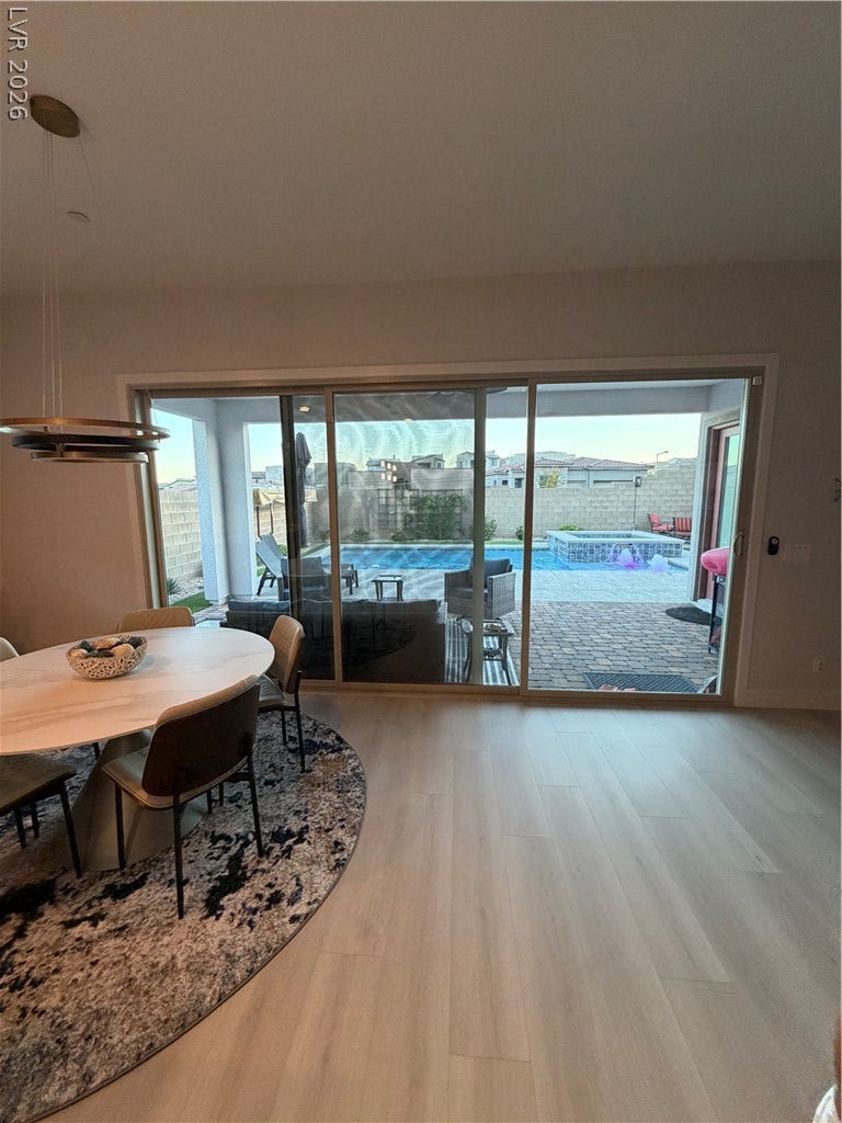 11725 Hatchling Avenue, Las Vegas, NV 89138 A sliding glass door opens to the patio from this modern dining area.