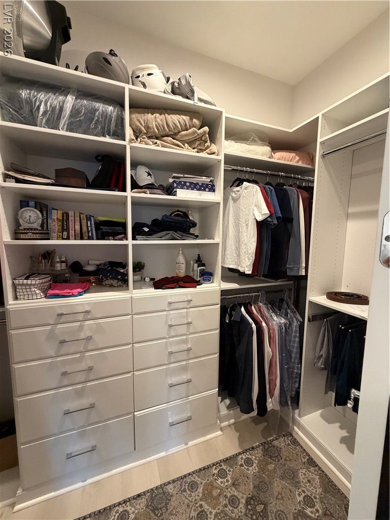 11725 Hatchling Avenue, Las Vegas, NV 89138 Ample custom shelving and integrated dresser drawers maximize storage in this master walk-in closet.