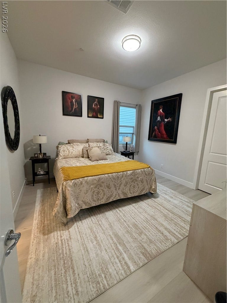 11725 Hatchling Avenue, Las Vegas, NV 89138 Smooth plaster walls and light luxuy vinyl flooring define this comfortable sleeping space.
