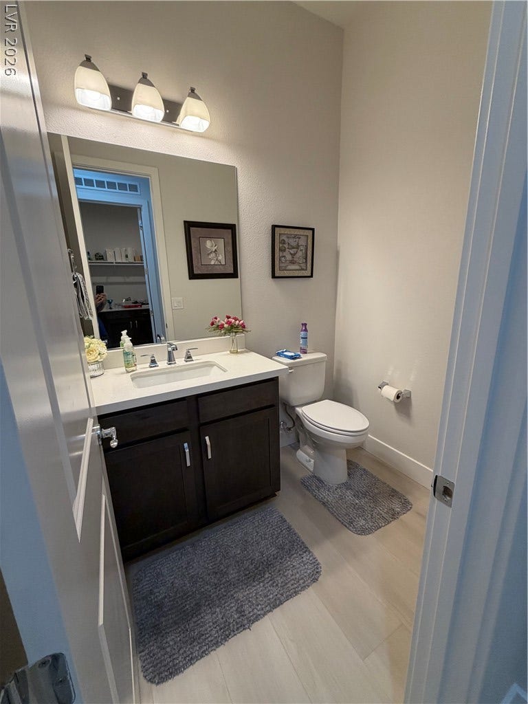 11725 Hatchling Avenue, Las Vegas, NV 89138 A modern vanity with dark cabinetry and luxuy vinyl flooring updates this pristine half bathroom.
