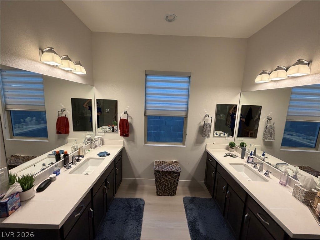 11725 Hatchling Avenue, Las Vegas, NV 89138 Dual vanities topped with quartz counters face each other in this bright bathroom.