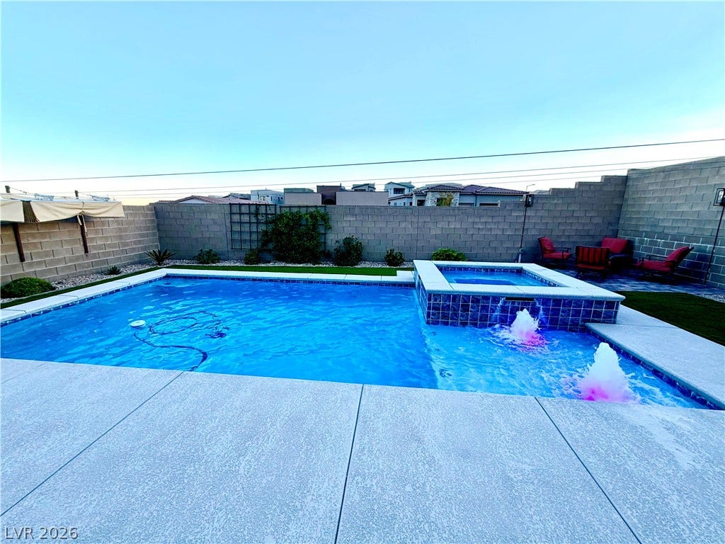 11725 Hatchling Avenue, Las Vegas, NV 89138 An inviting backyard oasis features a clean concrete deck and a modern pool.
