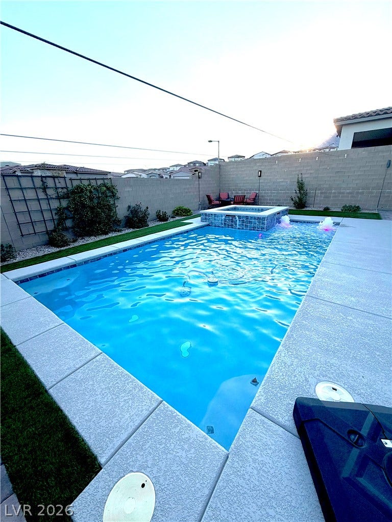 11725 Hatchling Avenue, Las Vegas, NV 89138 An inviting backyard oasis features a glistening in-ground pool paired with an integrated spa.