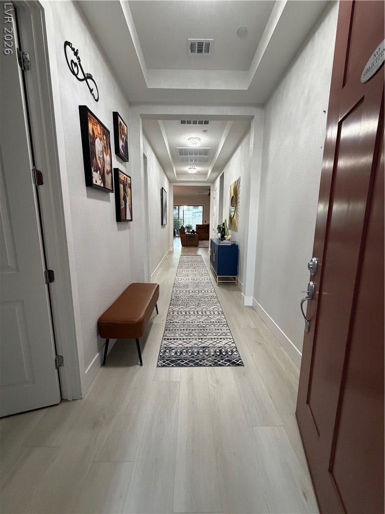 11725 Hatchling Avenue, Las Vegas, NV 89138 Crisp white walls and light-toned luxuy vinyl flooring guide guests down a welcoming entry hall.