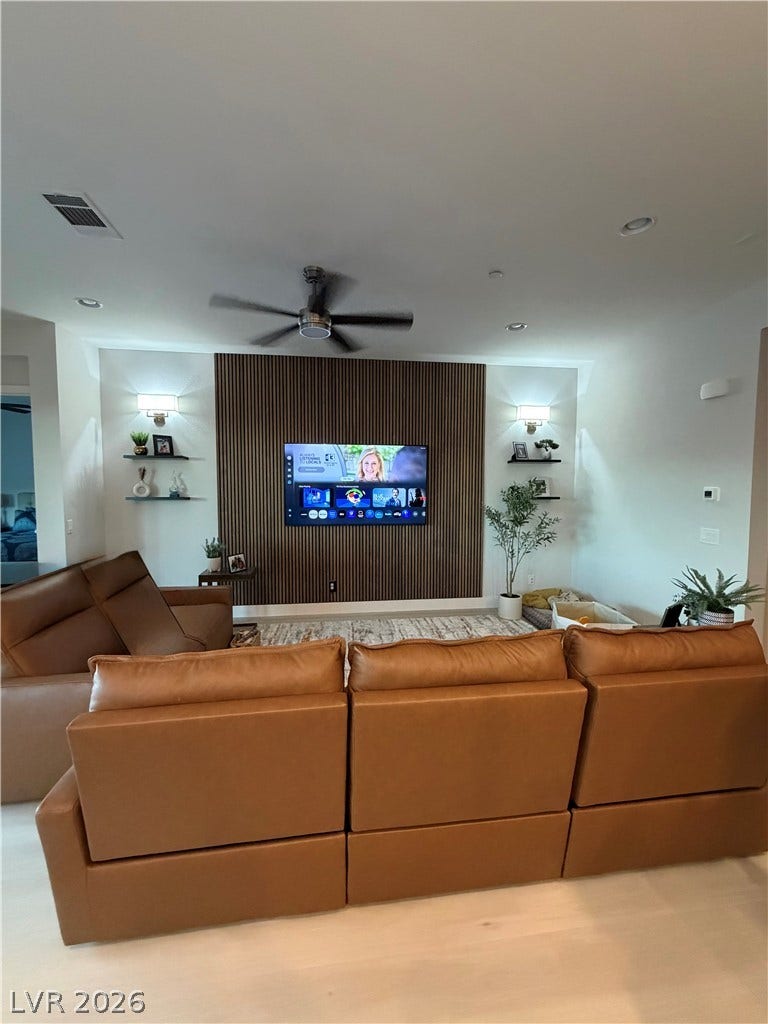 11725 Hatchling Avenue, Las Vegas, NV 89138 A modern media wall highlights this comfortable living space with clean lines and recessed lighting.