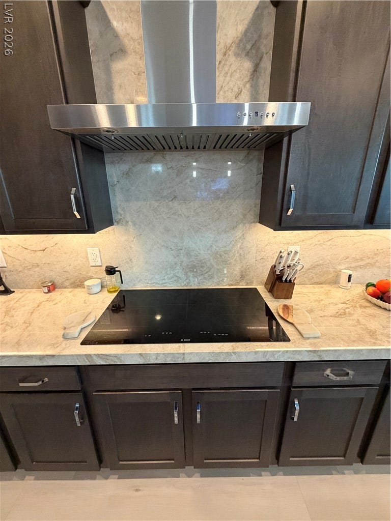 11725 Hatchling Avenue, Las Vegas, NV 89138 Rich dark cabinetry pairs beautifully with Quartzsite counters and a modern Bosch Induction cooktop area.