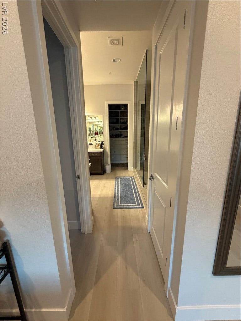 11725 Hatchling Avenue, Las Vegas, NV 89138 Gleaming luxury vinyl floors and crisp white trim line the hallway into your master bathroom.