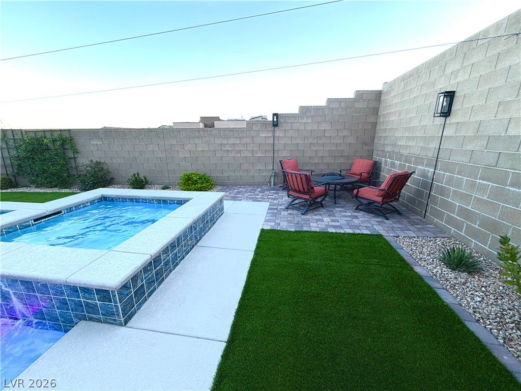 11725 Hatchling Avenue, Las Vegas, NV 89138 An inviting backyard oasis features a tiled spa with a cascading waterfall.