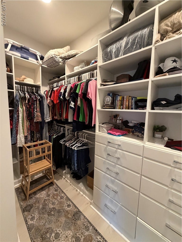 11725 Hatchling Avenue, Las Vegas, NV 89138 A spacious custom master closet system features extensive built-in shelving, drawers, and hanging rods.
