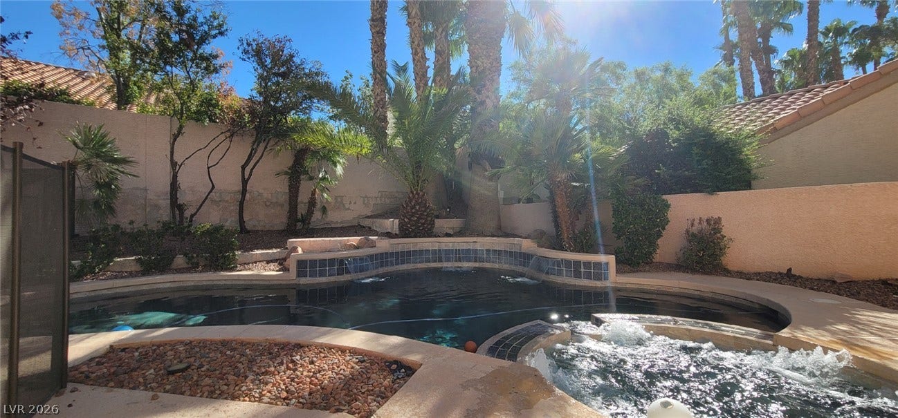2001 Silverton Drive, Henderson, NV 89074 Towering palm trees frame an inviting swimming pool and spa in a private backyard setting.