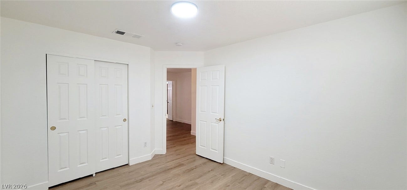 2001 Silverton Drive, Henderson, NV 89074 Smooth wood-look flooring and crisp white trim enhance this versatile bedroom space.