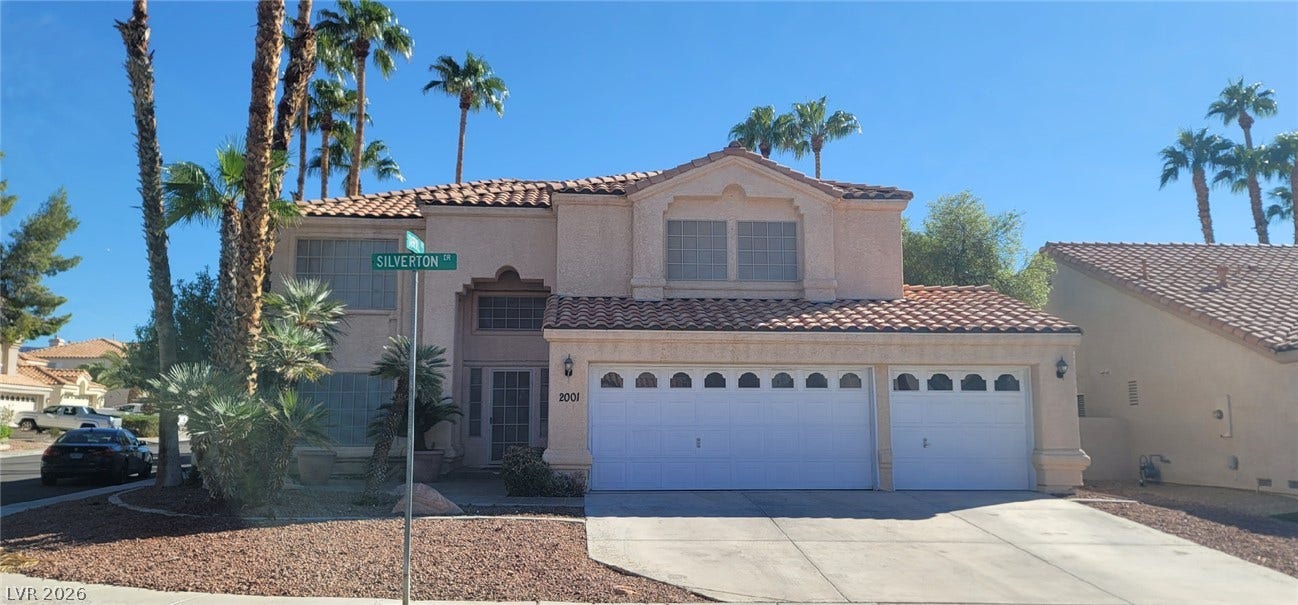 2001 Silverton Drive, Henderson, NV 89074 Spanish tile roofing and towering palm trees define this classic desert exterior architecture.