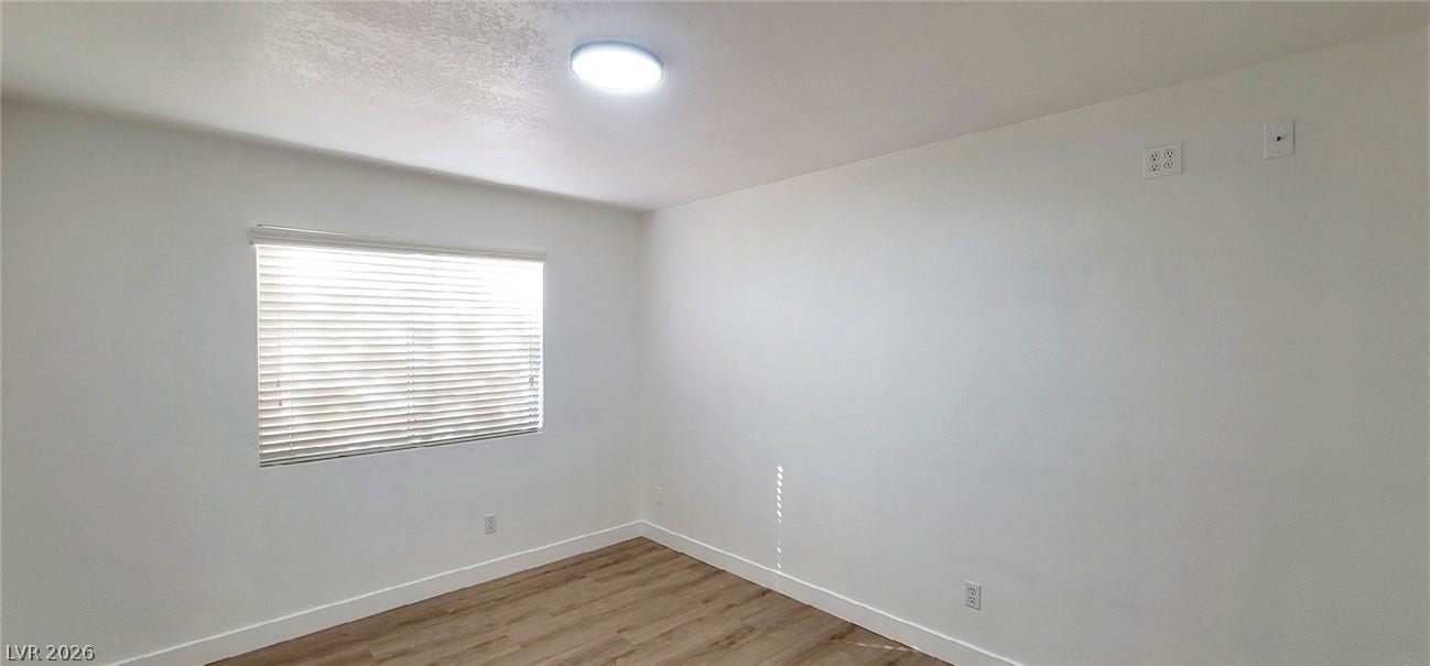 2001 Silverton Drive, Henderson, NV 89074 Gleaming wood floors anchor this versatile room illuminated by natural light.