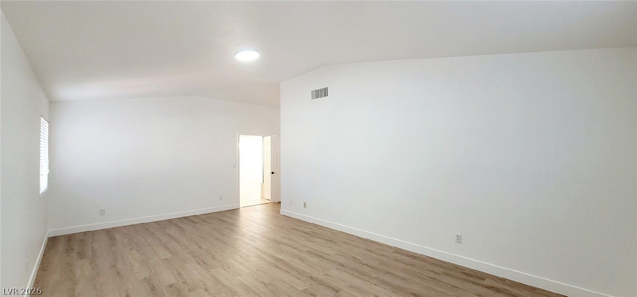 2001 Silverton Drive, Henderson, NV 89074 Gleaming wood-look floors complement the clean lines of this vaulted living space.