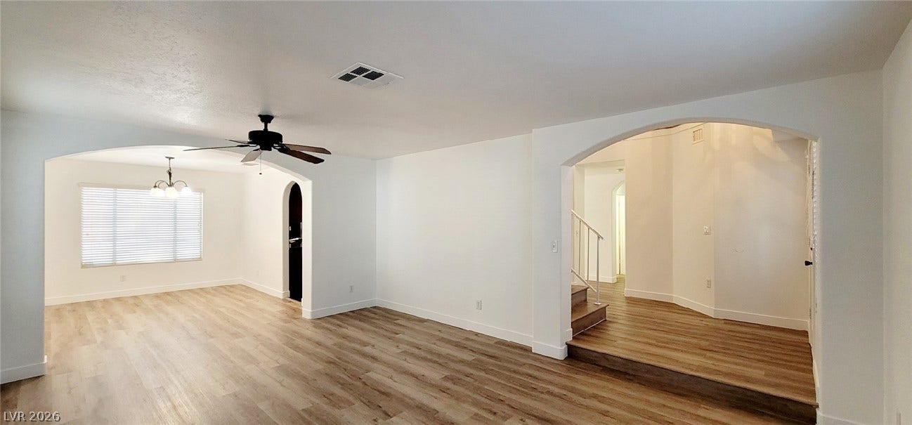 2001 Silverton Drive, Henderson, NV 89074 Graceful archways and rich wood-style flooring anchor this versatile open-concept living space.