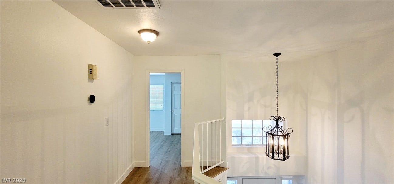 2001 Silverton Drive, Henderson, NV 89074 A well-lit upper landing connects the stairs to adjacent rooms over wood-style flooring.