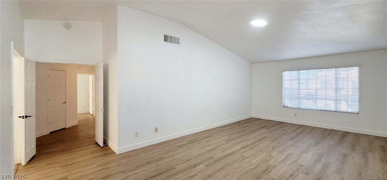 2001 Silverton Drive, Henderson, NV 89074 Vaulted ceilings and wood-style flooring create an airy atmosphere throughout the open living area.