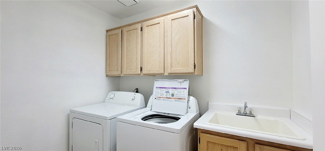 2001 Silverton Drive, Henderson, NV 89074 A functional laundry area includes built-in cabinetry and a deep utility sink.