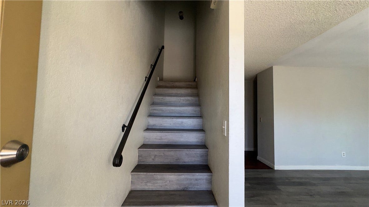 543 KRISTIN Lane, Henderson, NV 89011 Smooth wood-plank stairs ascend to the upper level adjacent to the main living area.