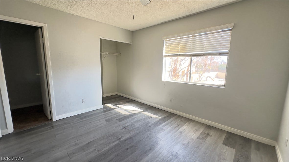 543 KRISTIN Lane, Henderson, NV 89011 Natural light streams across wood-look flooring through a wide window.