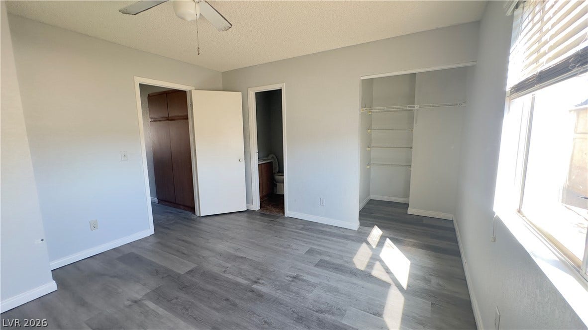 543 KRISTIN Lane, Henderson, NV 89011 Sunlight streams across the contemporary wood-look flooring of this versatile bedroom space.