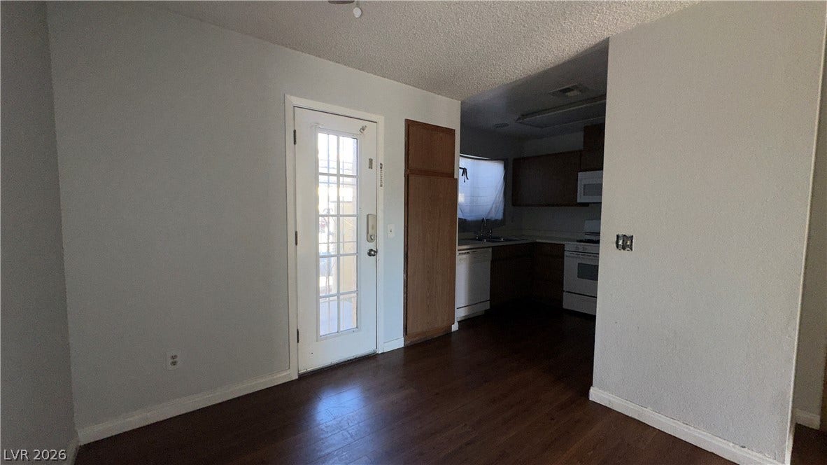 543 KRISTIN Lane, Henderson, NV 89011 A glass-paneled entry door opens directly into a versatile living space with wood flooring.