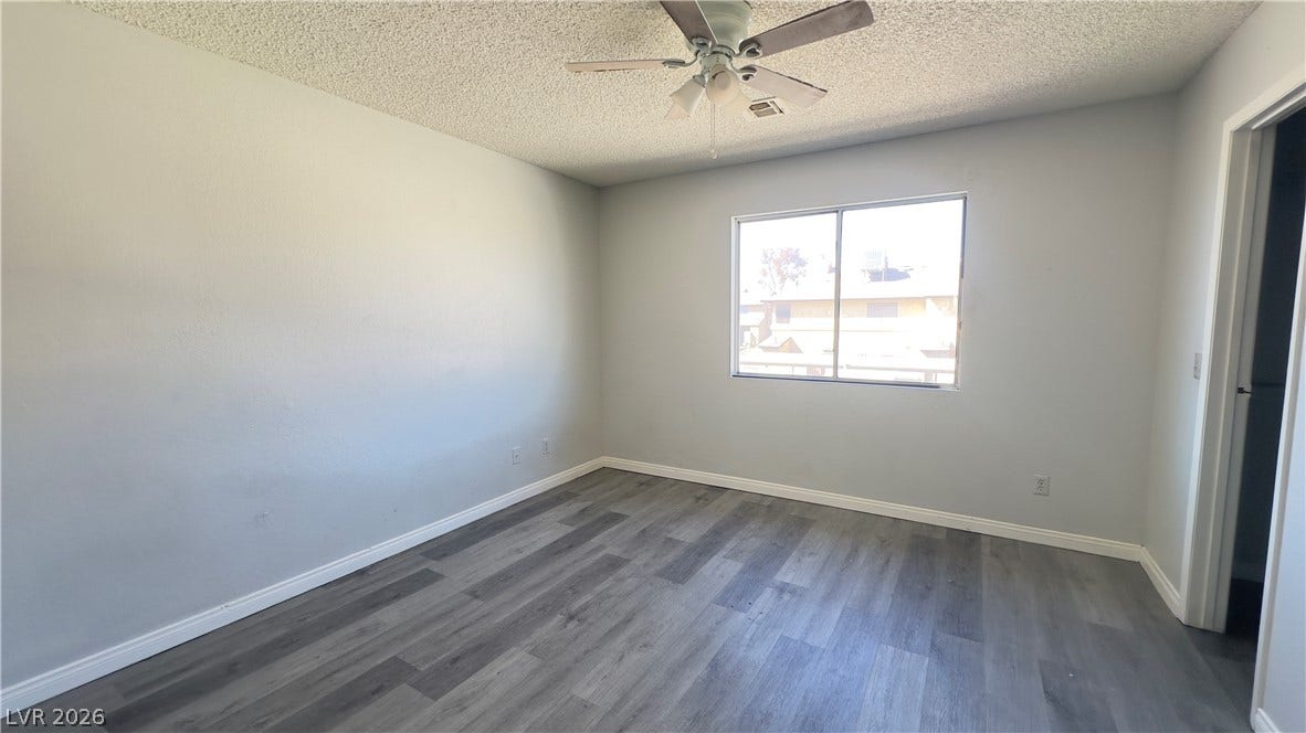 543 KRISTIN Lane, Henderson, NV 89011 Natural light streams through a wide window illuminating the modern wood-plank flooring.
