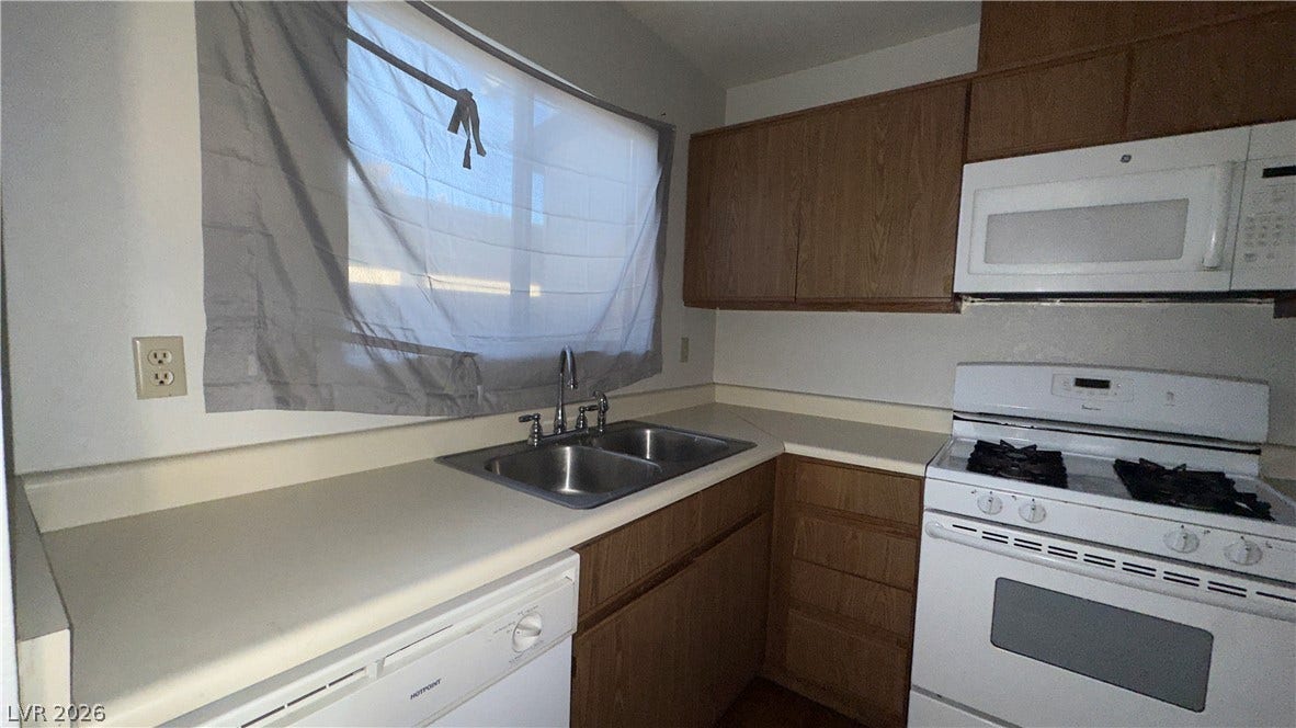 543 KRISTIN Lane, Henderson, NV 89011 A window above the sink illuminates the functional layout and wood cabinets of this kitchen.
