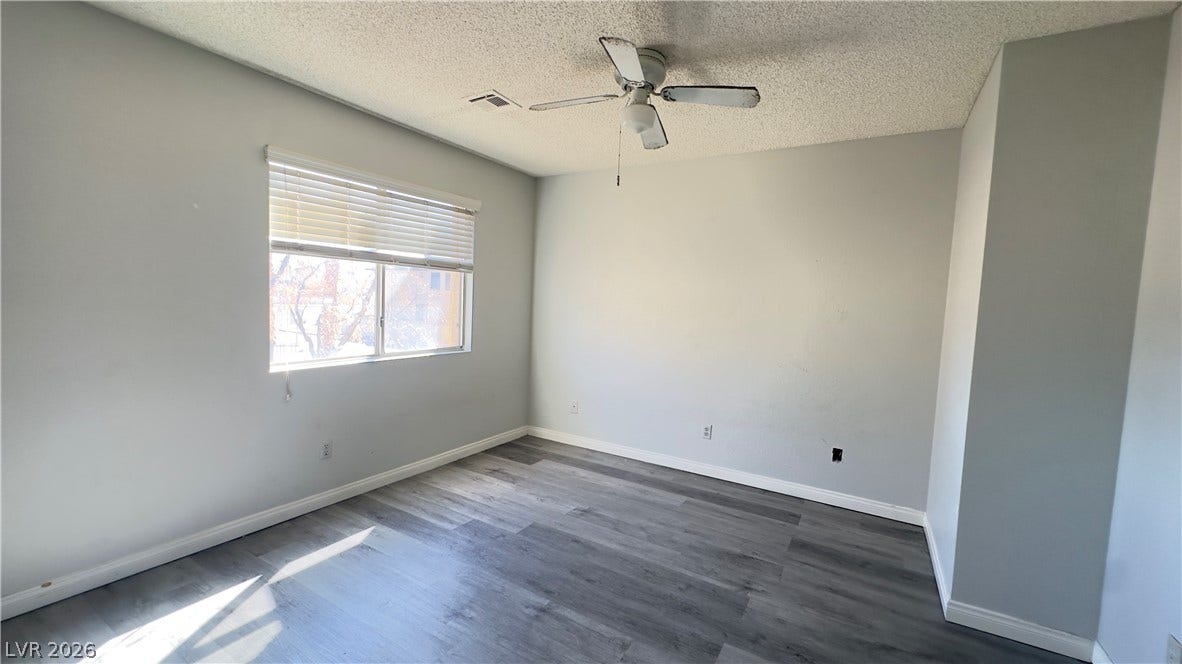 543 KRISTIN Lane, Henderson, NV 89011 Natural light pours across the plank flooring of this versatile bedroom space.