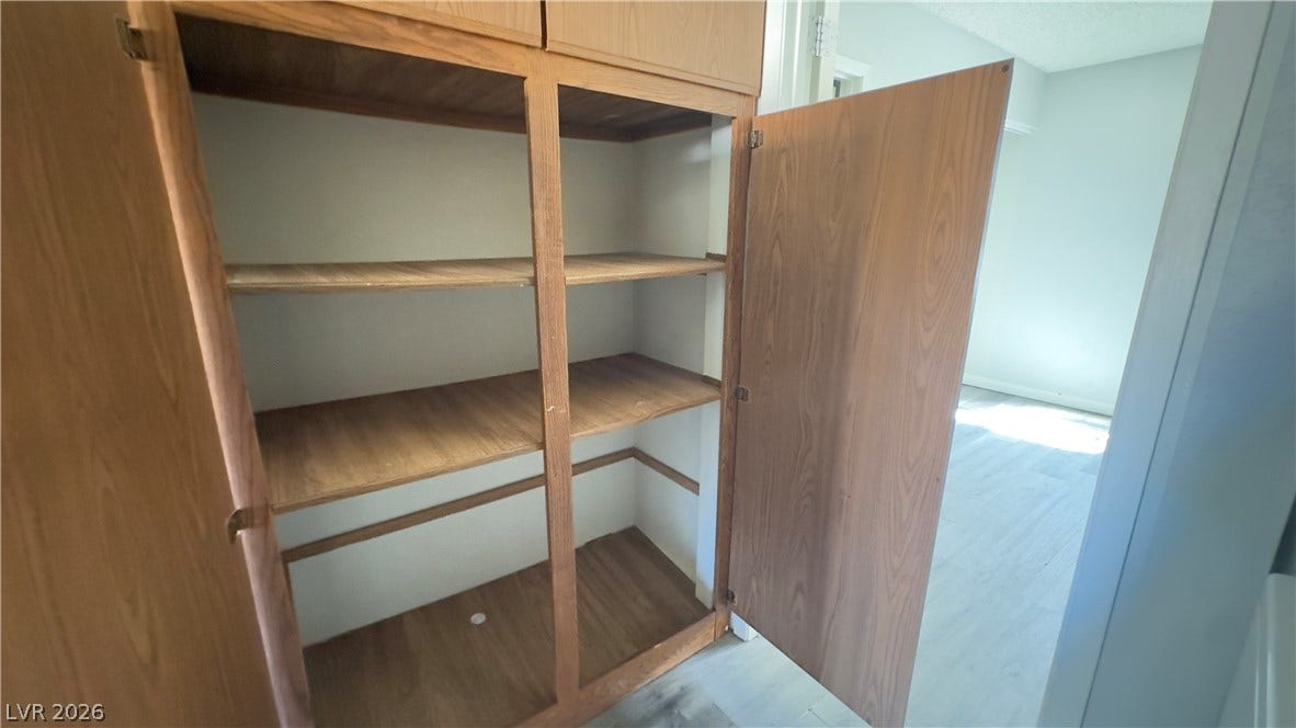 543 KRISTIN Lane, Henderson, NV 89011 Ample built-in wooden shelving provides excellent storage potential in this versatile home.