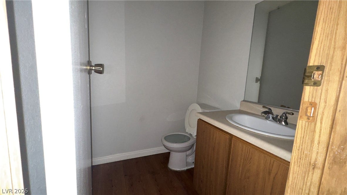 543 KRISTIN Lane, Henderson, NV 89011 A functional half bath features wood-look flooring and a simple single vanity cabinet.